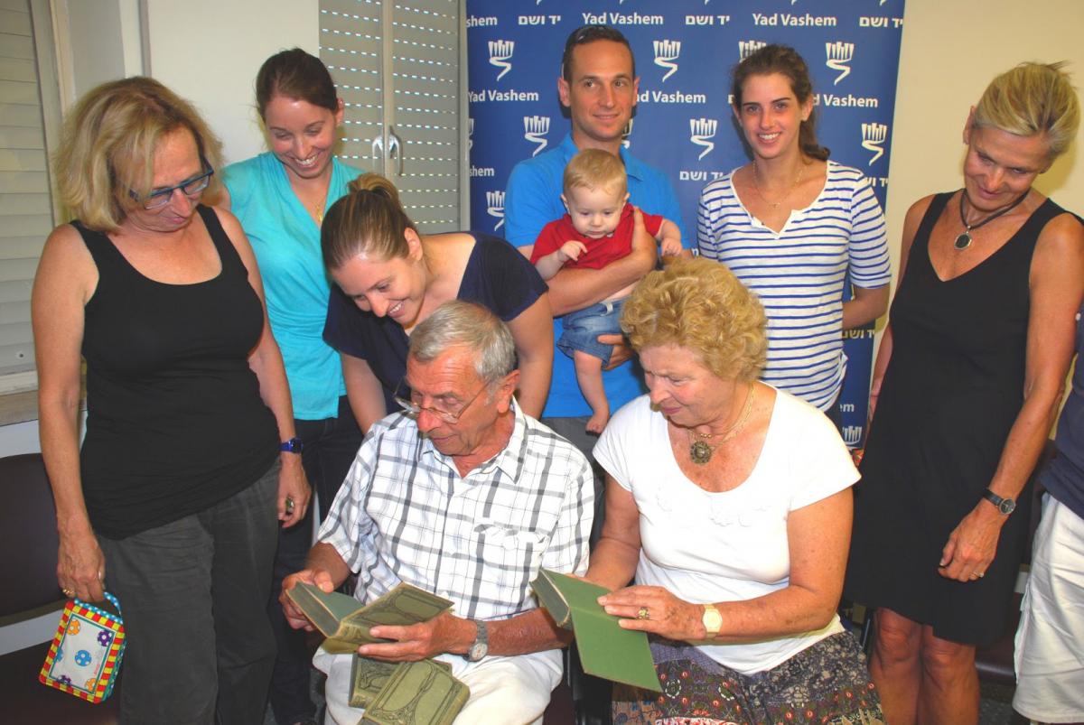 Moshe Hofstadter and his family look at this father’s books at Yad Vashem